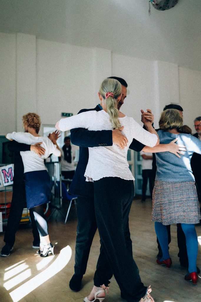 pexels photo 15792473 15792473 A group of adults practicing ballroom dancing in a sunlit indoor studio, capturing elegance and grace.